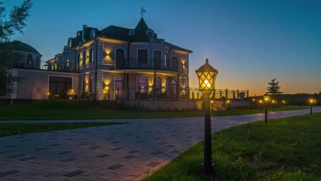 evening becomes night by large luxurious villa, static timelapse