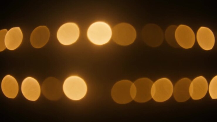 Abstract Golden Bokeh Lights Glowing in the Dark
