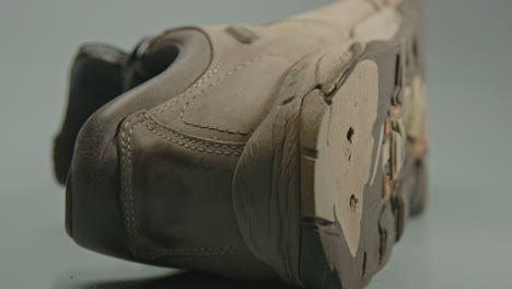 dolly of a worn hiking boot with holes in shoe sole