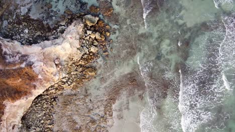 a bird's eye aerial view of a colorful, rocky coast line in thailand