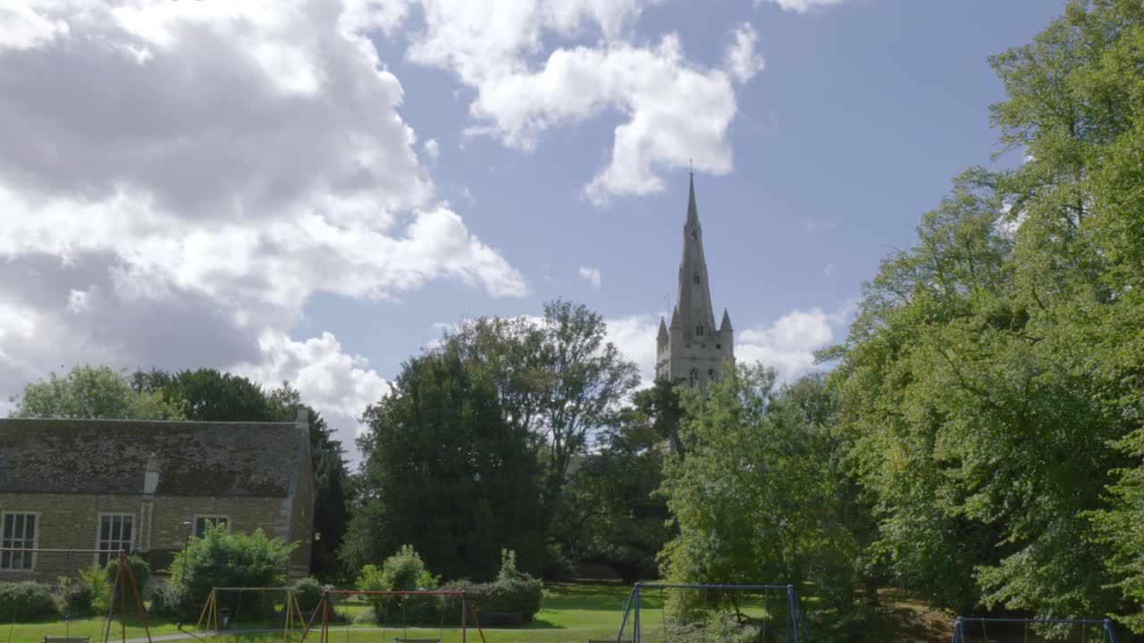 Sunny day in Oakham with church spire and lush garden scenery