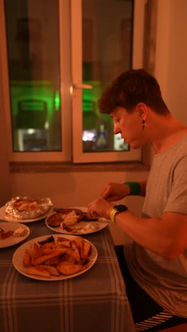 hombre comiendo comida a la parrilla en casa