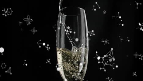 pouring champagne into glass over molecular structure animation on black background