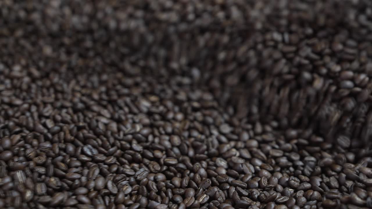 Dark roasted coffee beans displayed with clear surface texture