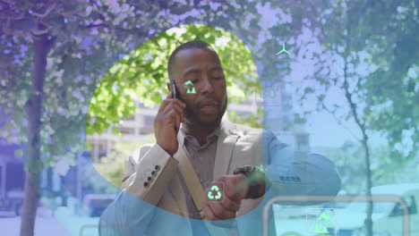 animation of eco icons and data processing over afrcian american man using smartphone