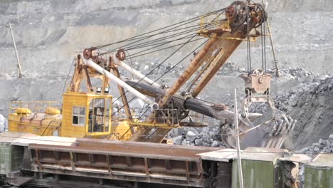 mining excavator loading ore onto train