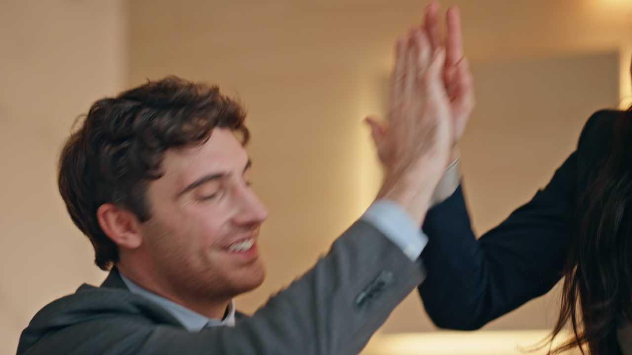 Closeup surprised colleagues rejoicing business at buro. Joyful team working