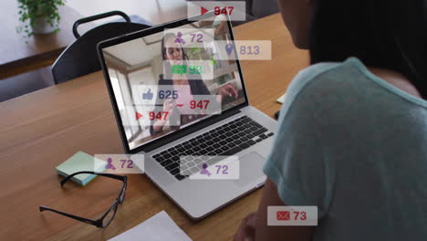 animation of icons and numbers over diverse business people using laptop in office