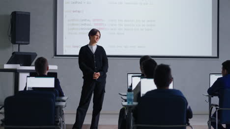 teenager teaching computer science class