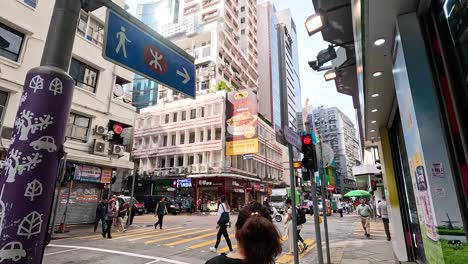 pedestrians crossing at a bustling city intersection