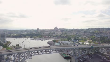 Drone-Flying-Over-Vancouver-and-Spinning-Camera-Trough-Bridge-in-British-Columbia,-Canada