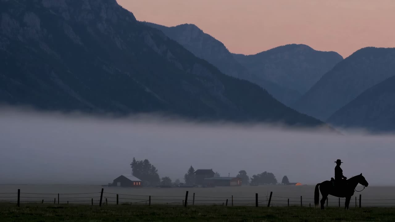 Cowboy on Horseback in Misty Valley