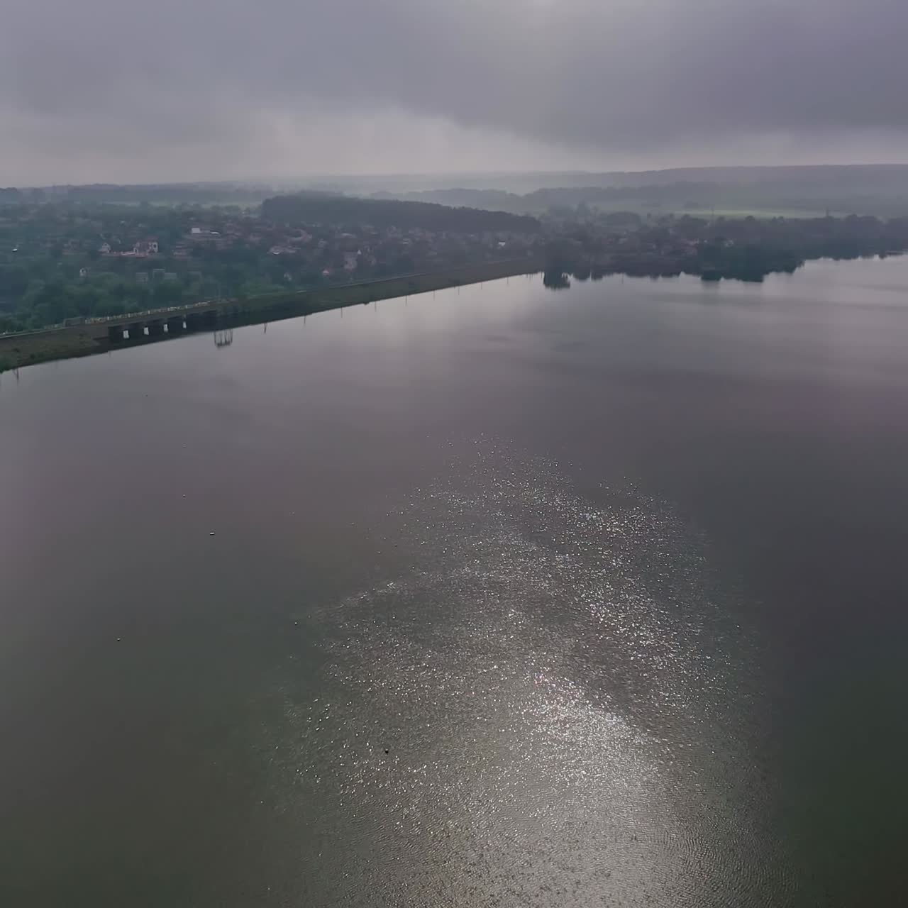 River at sunset. Beautiful view of a huge river in nature landscape. Shining of water at the evening sun. Aerial view.