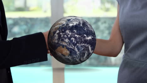 animation of globe over businessman handshake