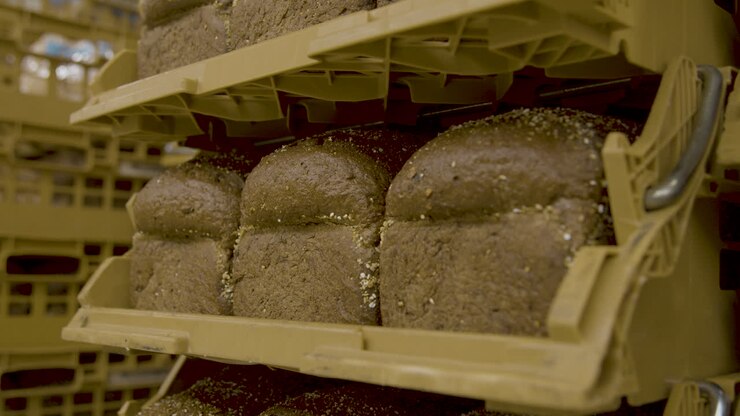 Dark bread stacked in storage baskets
