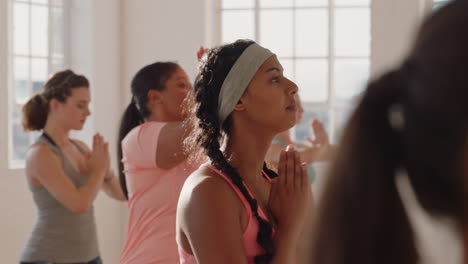 yoga class beautiful mixed race woman practicing prayer pose enjoying fitness lifestyle multi ethnic group of people exercising in studio at sunrise