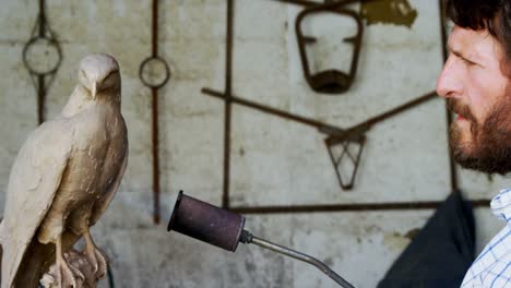 craftsman preparing bird sculpture 4k