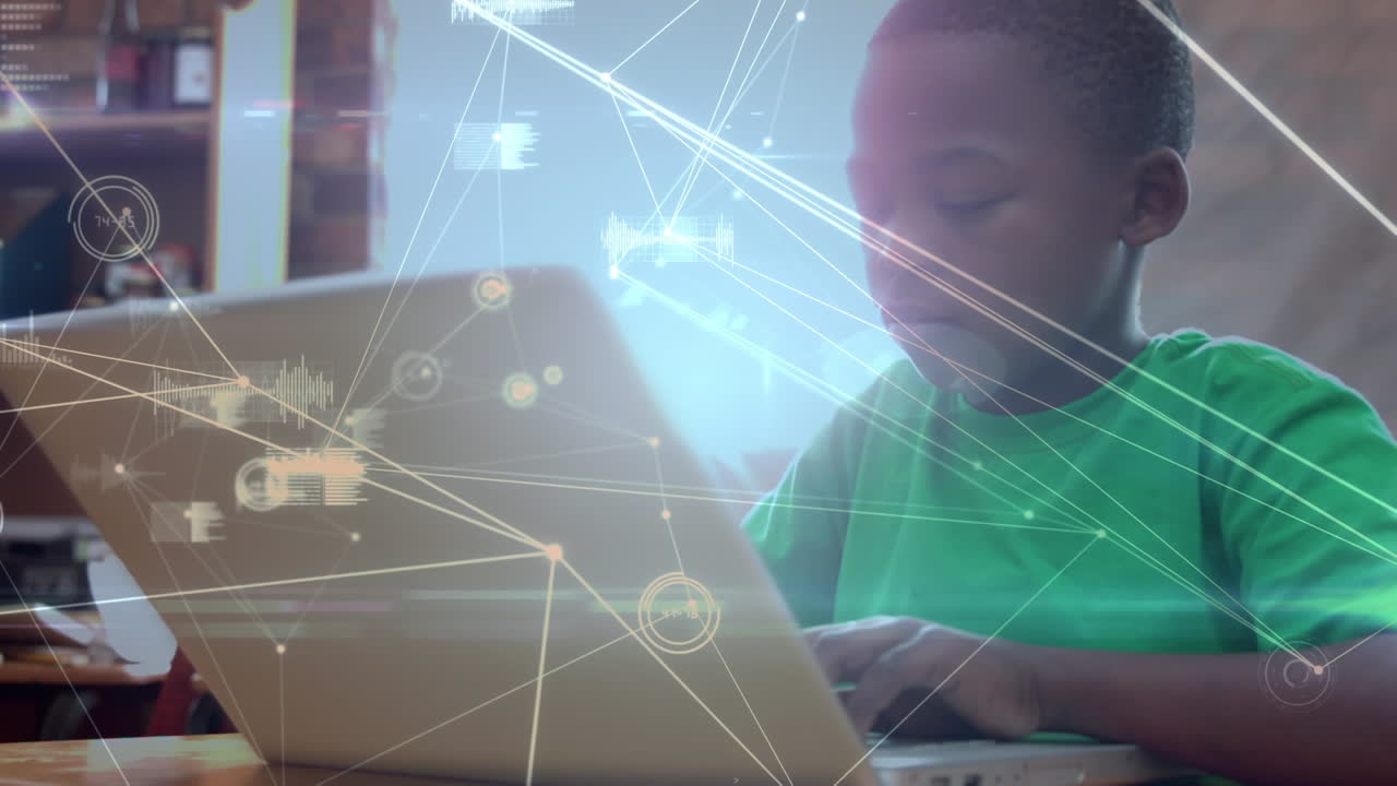 Boy using a laptop at school with data