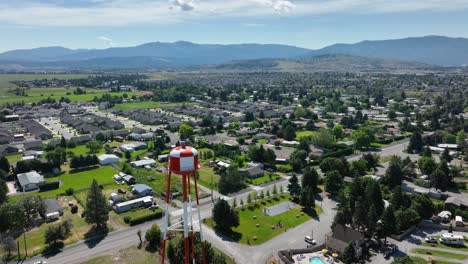 Orbiting-aerial-shot-of-a-water-tower-in-middle-class-America