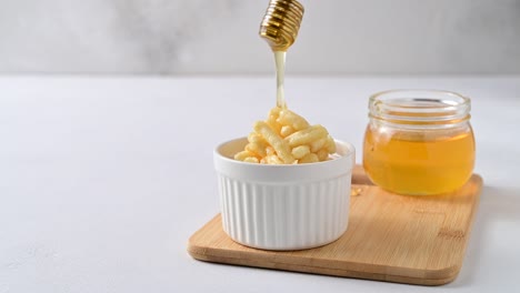 honey is pouring from a honey dipper onto a chuck chuck.