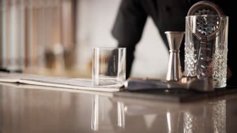 bartender adding ice to a glass