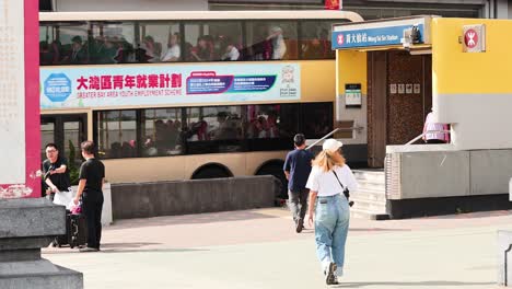 people walking near a temple entrance in hong kong