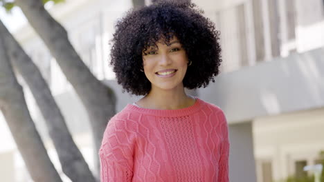 Portrait-of-happy-african-american-woman-with-with-curly-hair-in-garden-at-home,-slow-motion