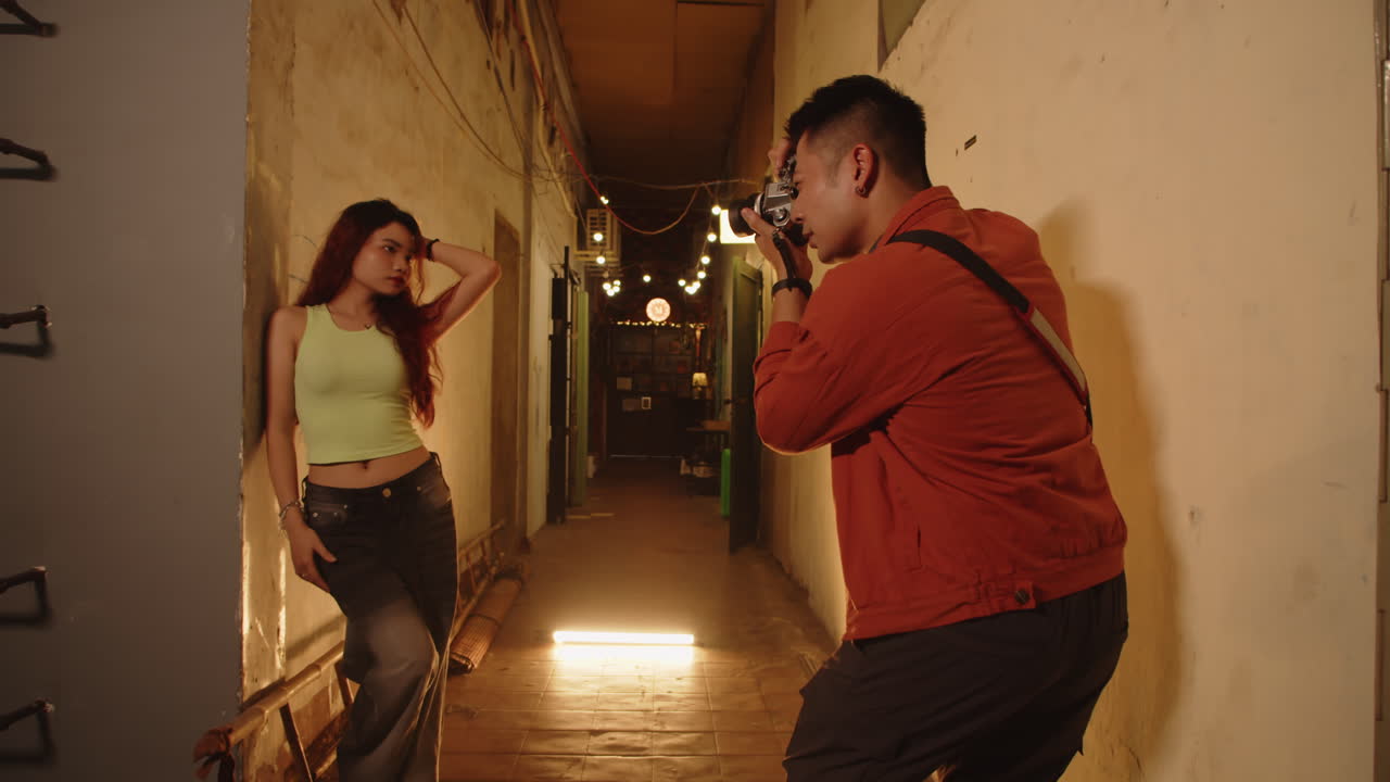 Photographer taking photos of a model in an alleyway