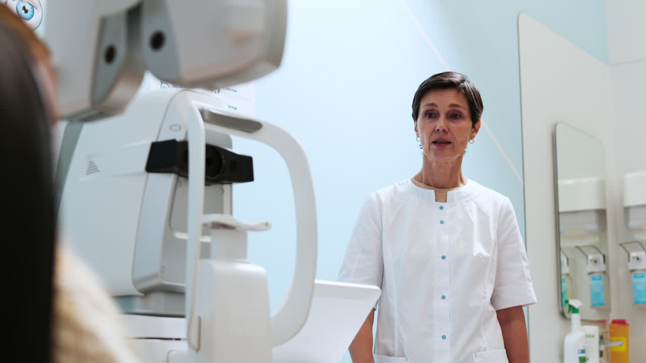 Ophthalmologist adjusting phoropter