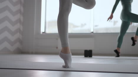 close-up of a female ballerina walking on socks without pointe shoes. training of the feet of women ballerinas in slow motion