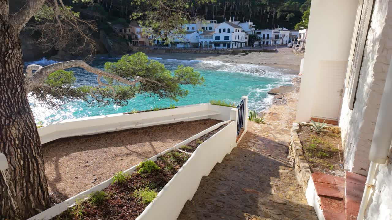 Tamariu Beach in Costa Brava de Girona super slow motion white houses in front of the Mediterranean Sea