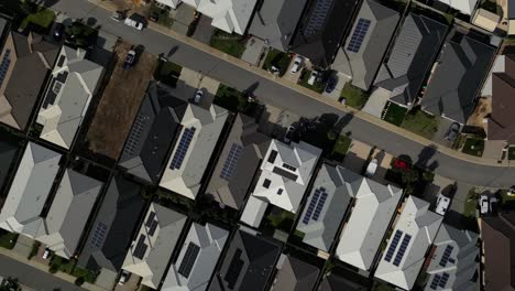 houses with solar panels on the roof, aerial top down