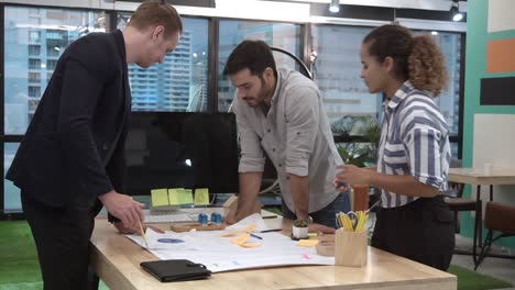 Creative-business-people-group-having-conversation-at-office-desk-in-workplace.