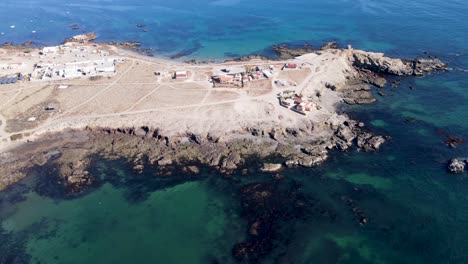 Vista-Aérea-De-La-Península-De-Bahia-Asunción-Y-Una-Idílica-Casa-De-Lujo-En-Lo-Alto-De-Un-Acantilado-Marino,-México