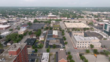 Train-moving-in-downtown-Joliet,-Illinois-with-drone-video-moving-forward