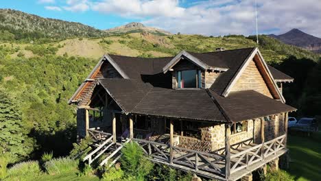 Front-of-dreamy-wood-and-stone-house-in-mountains-at-sunset-in-Slow-motion-vertical-travelling