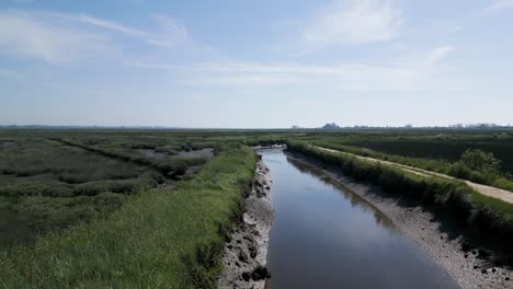 Serene-water-channel-along-the-Veiros-Trail-near-Murtosa,-Aveiro,-Portugal