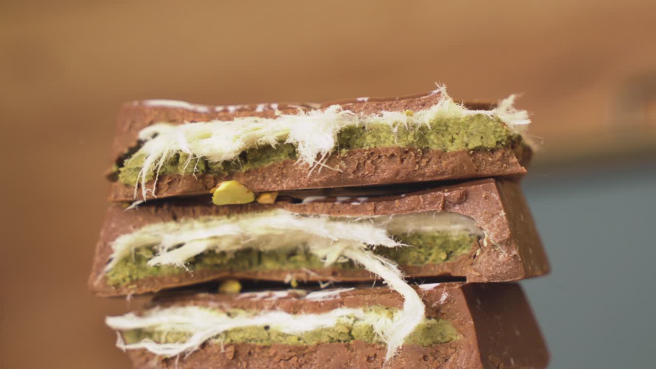 A close-up view of luxurious Dubai chocolate topped with crushed pistachios, showcasing its rich texture and fine craftsmanship