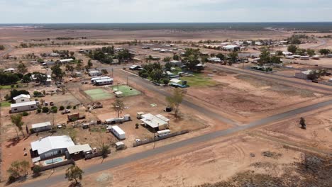 drone flying towards a very small country town in the australian outback