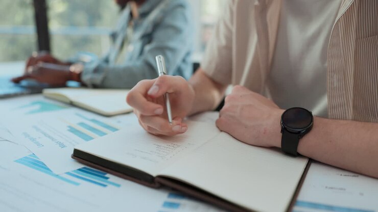 People in an office taking notes and discussing
