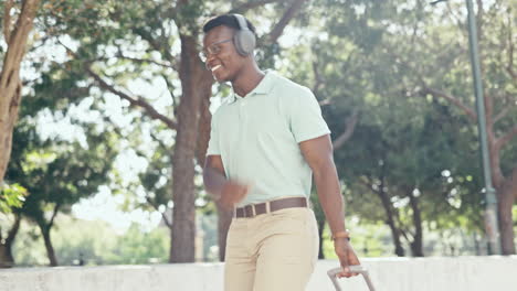 Music,-happiness-and-black-man-headphones-in-park