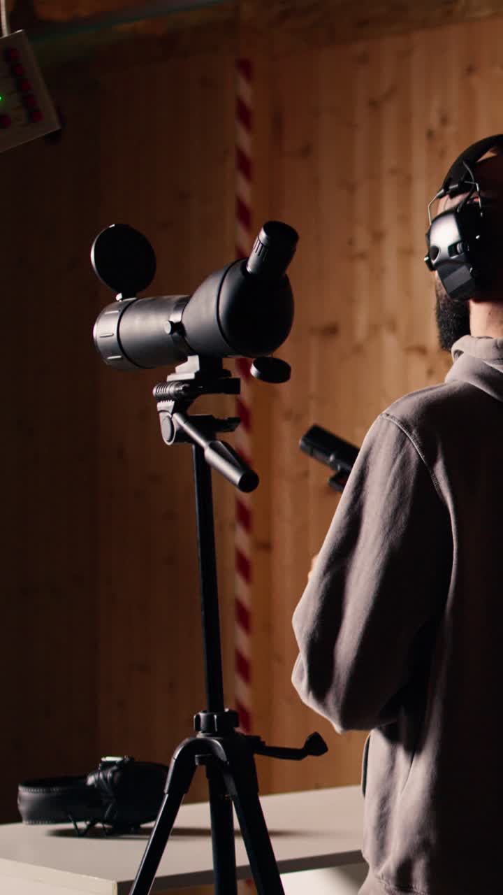 Vertical video Firing range client doing shooting activity next to friends, comparing shots