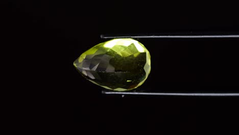 natural yellow citrine in the tweezer on the turning table