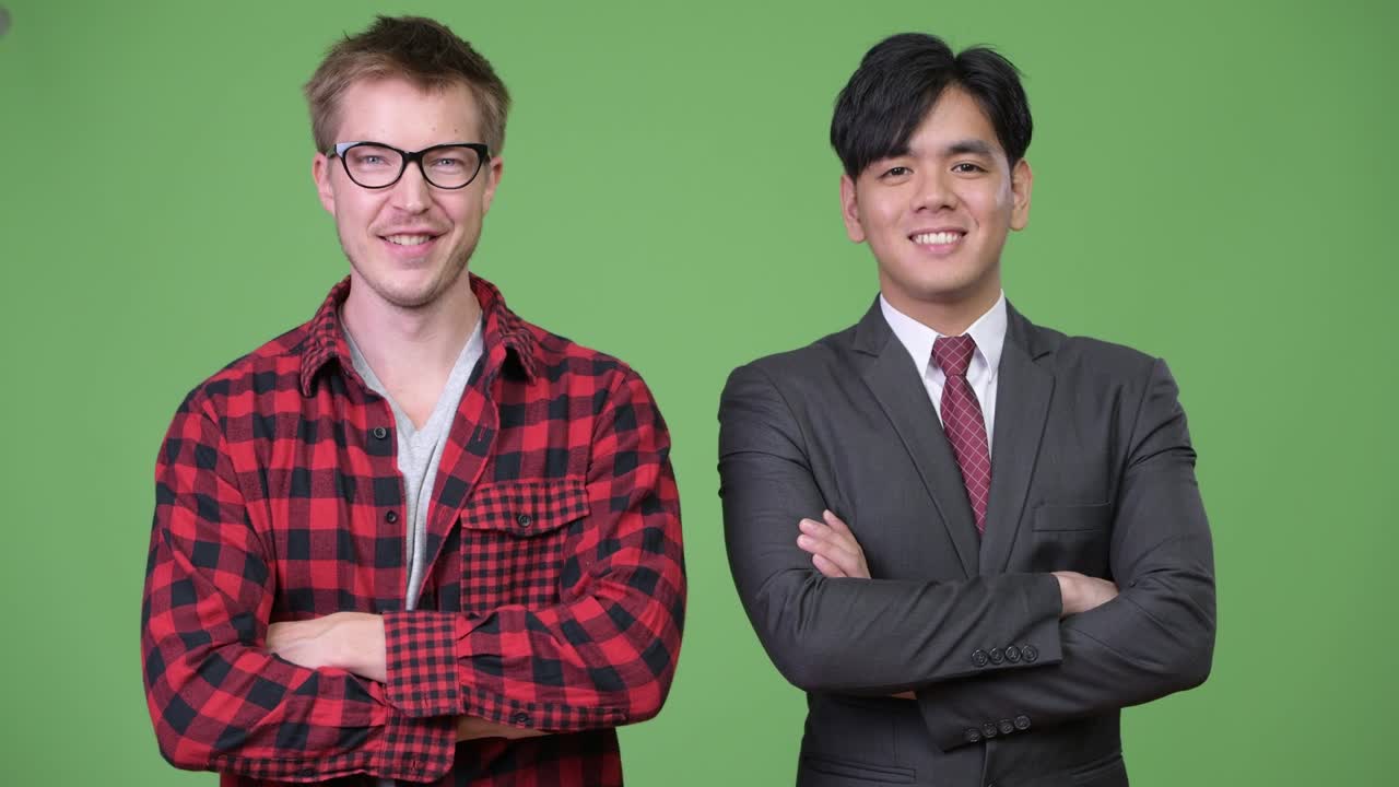 Young handsome Asian businessman and young Scandinavian businessman working together