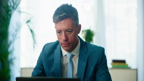 smiling businessman in a suit looking at the camera