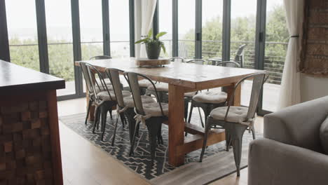 general view of dining room with table and chairs, slow motion