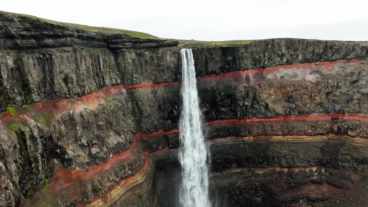 Aerial view of Hengifoss Waterfall in Iceland. Volcanic erosion Mountains. Cloudy day in Iceland