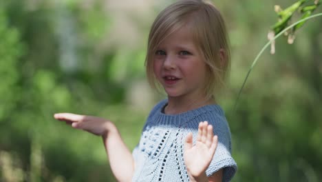 a young fair-haired girl poses for the camera