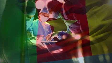 Animation-of-flag-of-cameroon-waving-over-surgeons-in-operating-theatre