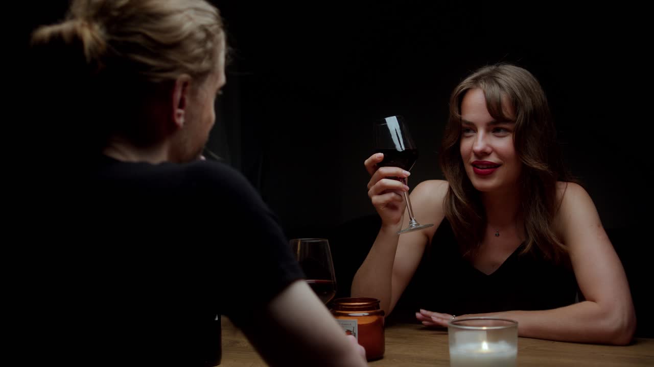 Romantic Couple Enjoying Wine and Conversation at Dinner